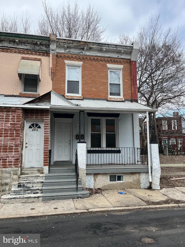 view of front of property with brick siding and a porch