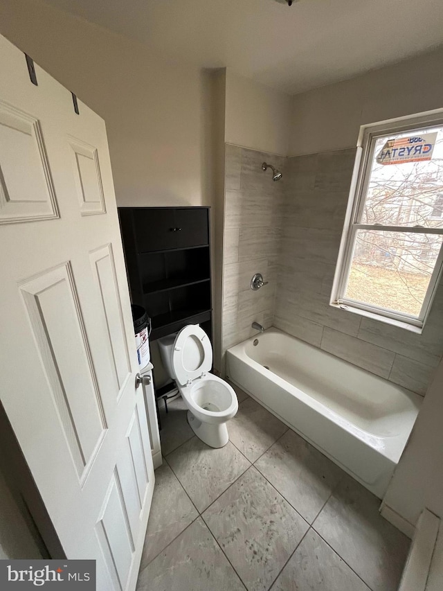full bath with toilet, tile patterned flooring, and  shower combination