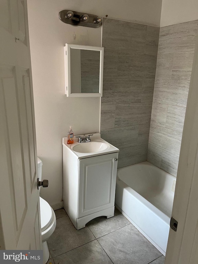full bath featuring vanity, toilet, and tile patterned flooring
