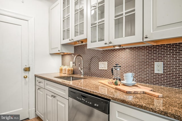 kitchen with a sink, stone countertops, white cabinetry, backsplash, and dishwasher