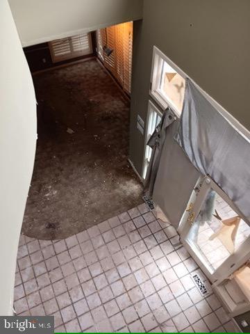 hallway with tile patterned floors