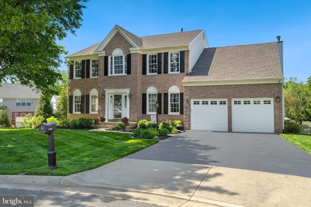 15014 Plastron Ct, Woodbridge, VA 22193 - colonial house with roof with shingles, driveway, brick siding, an attached garage, and a front yard