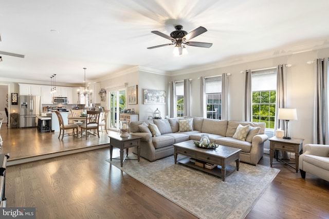 15014 Plastron Ct, Woodbridge, VA 22193 - living area featuring ceiling fan with notable chandelier, dark wood finished floors, and crown molding