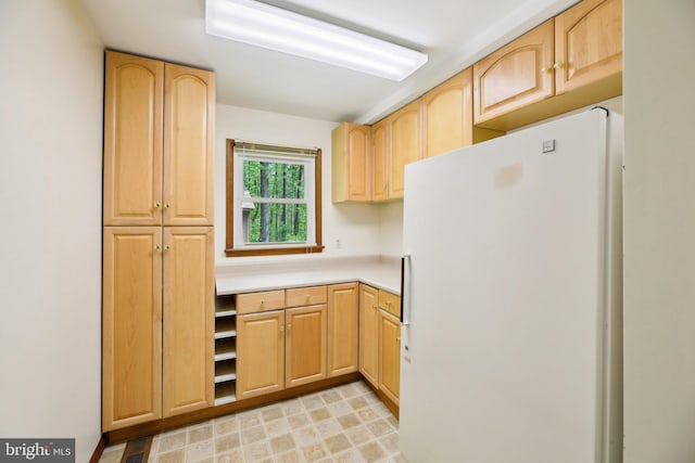 1326 Jones Station Rd, Arnold, MD 21012 - kitchen with freestanding refrigerator, light brown cabinetry, and light countertops