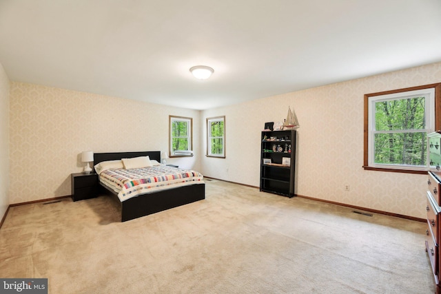 1326 Jones Station Rd, Arnold, MD 21012 - bedroom with wallpapered walls, visible vents, light carpet, and baseboards