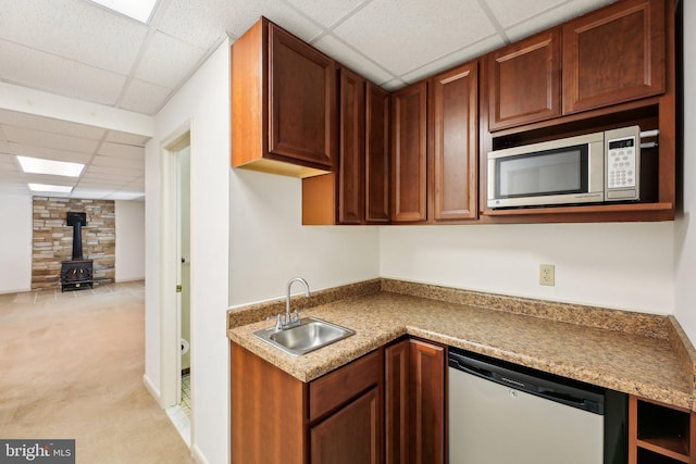 1326 Jones Station Rd, Arnold, MD 21012 - kitchen featuring a wood stove, a drop ceiling, stainless steel microwave, a sink, and dishwasher