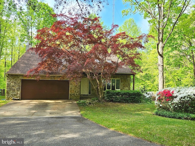 1326 Jones Station Rd, Arnold, MD 21012 - obstructed view of property featuring an attached garage, driveway, stone siding, and a front lawn