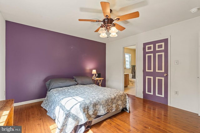 10257 Back Creek Valley Rd, Hedgesville, WV 25427 - bedroom with baseboards, ensuite bath, wood finished floors, and a ceiling fan