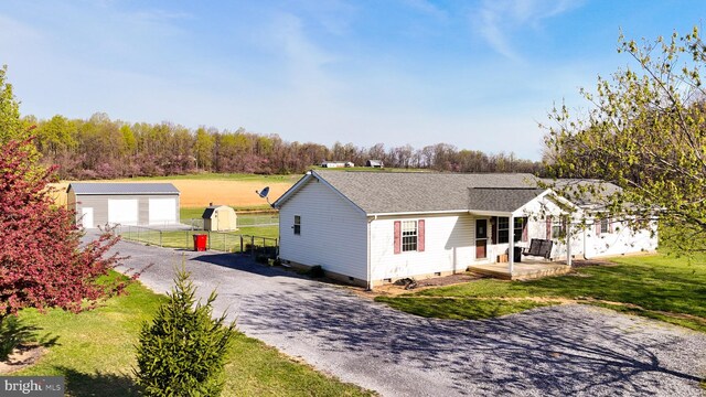 10257 Back Creek Valley Rd, Hedgesville, WV 25427 - single story home featuring crawl space, fence, an outbuilding, a front yard, and a garage