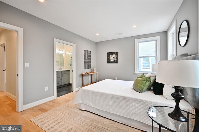 512 Peabody St NW, Washington, DC 20011 - bedroom featuring ensuite bathroom, light wood-type flooring, recessed lighting, a sink, and baseboards