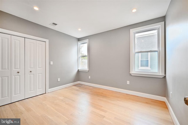 512 Peabody St NW, Washington, DC 20011 - unfurnished bedroom with visible vents, baseboards, and light wood-style floors