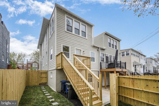 512 Peabody St NW, Washington, DC 20011 - back of property featuring a lawn, a fenced backyard, stairway, a wooden deck, and a residential view