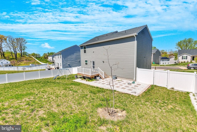 rear view of house with a yard, a patio area, and a fenced backyard