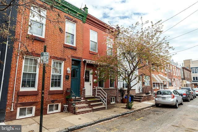 view of property with brick siding and a residential view