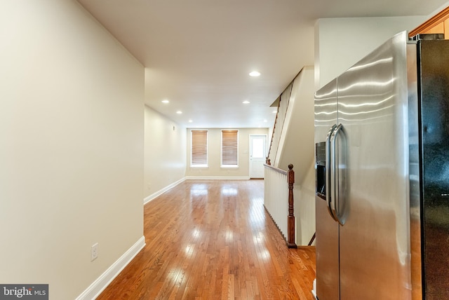 hall featuring recessed lighting, light wood-style flooring, an upstairs landing, and baseboards