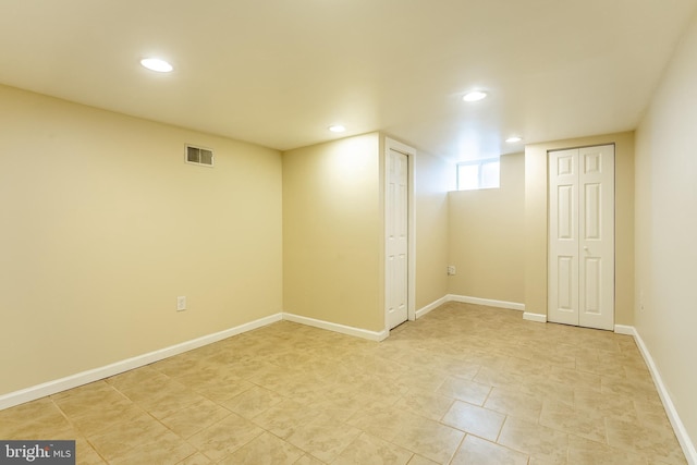 basement with light tile patterned floors, baseboards, visible vents, and recessed lighting