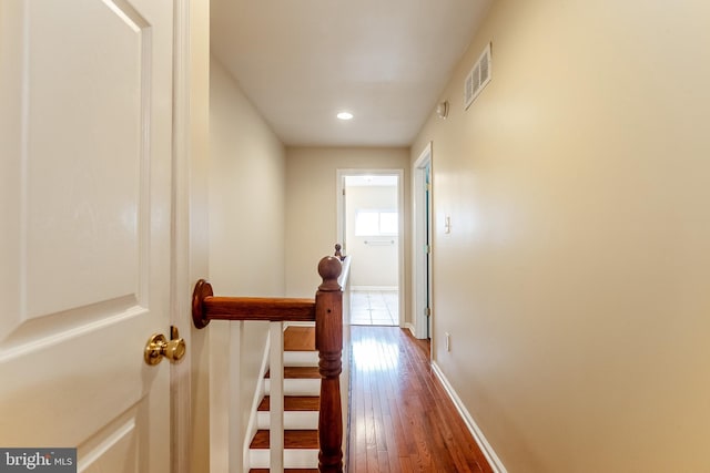 hallway featuring recessed lighting, dark wood-type flooring, visible vents, and baseboards