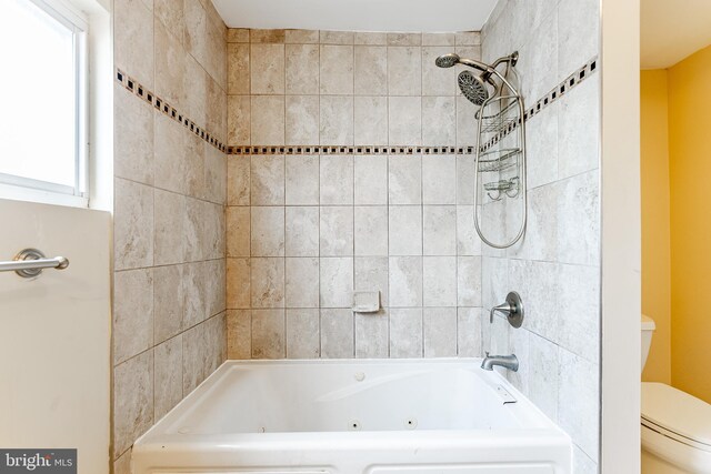 full bath with toilet and a combined bath / shower with jetted tub