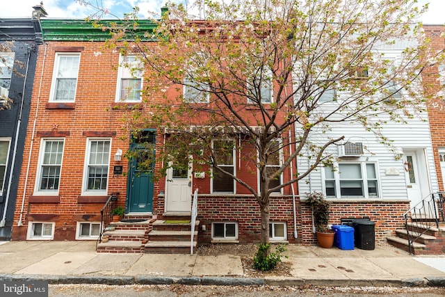 multi unit property featuring brick siding and entry steps