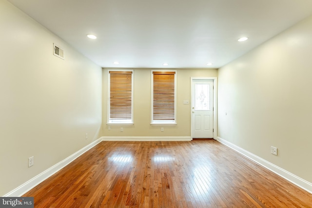 unfurnished room with visible vents, baseboards, recessed lighting, and wood finished floors