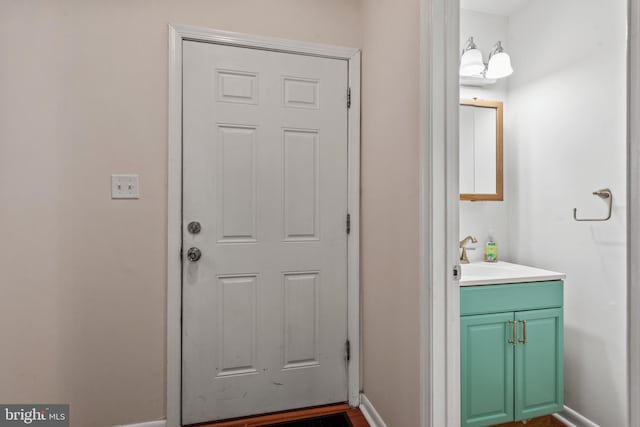 entryway with a sink and baseboards