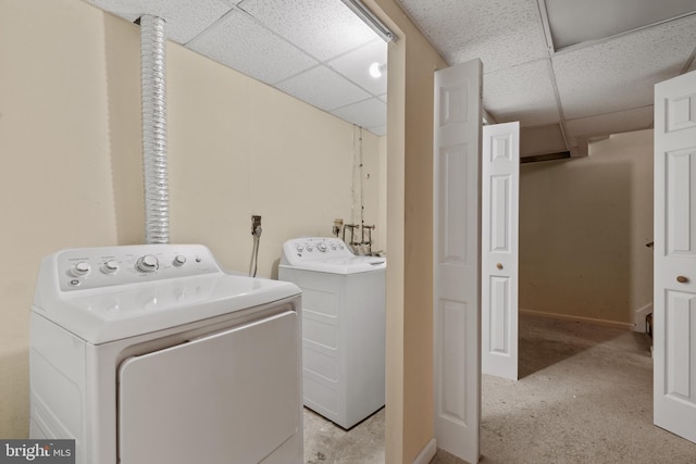 laundry room with baseboards and separate washer and dryer
