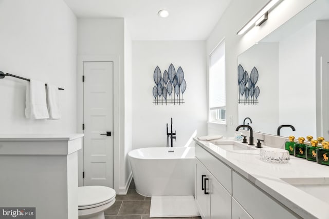 2237 N Hope St, Philadelphia, PA 19133 - full bath featuring tile patterned floors, a freestanding bath, double vanity, toilet, and a sink
