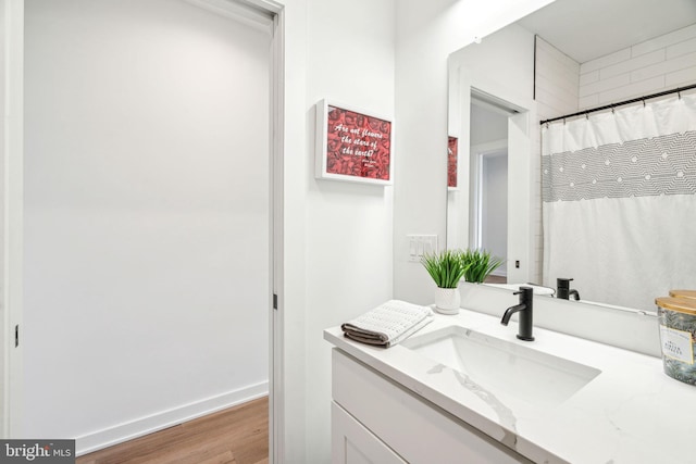 2237 N Hope St, Philadelphia, PA 19133 - bathroom featuring baseboards, wood finished floors, and vanity