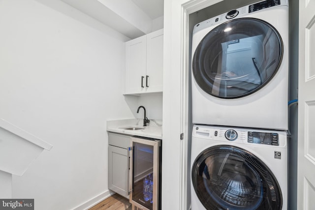 2237 N Hope St, Philadelphia, PA 19133 - laundry area with a sink, stacked washer / dryer, beverage cooler, wet bar, and laundry area
