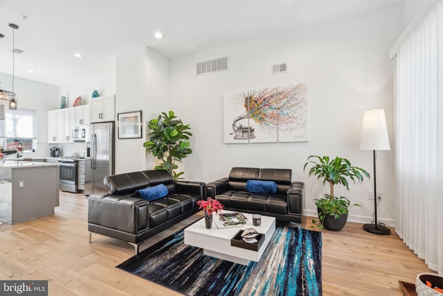 2237 N Hope St, Philadelphia, PA 19133 - living area featuring recessed lighting, visible vents, light wood finished floors, and baseboards