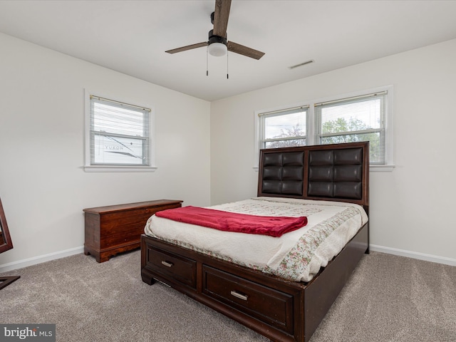 bedroom featuring light carpet, visible vents, and baseboards