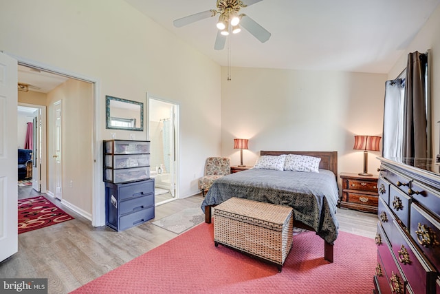 bedroom with wood finished floors, lofted ceiling, connected bathroom, and ceiling fan