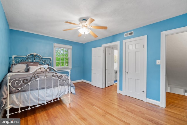 bedroom with hardwood / wood-style flooring, baseboards, and a ceiling fan