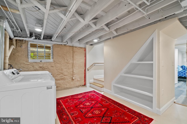 basement featuring separate washer and dryer and stairway