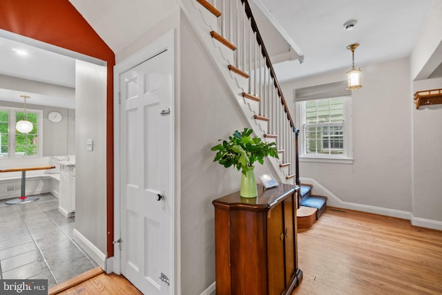 entrance foyer featuring light wood finished floors, stairway, and baseboards