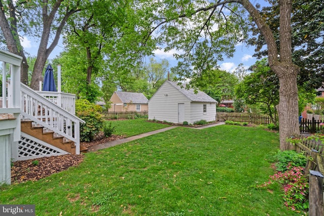 view of yard with stairs, an outdoor structure, and a deck