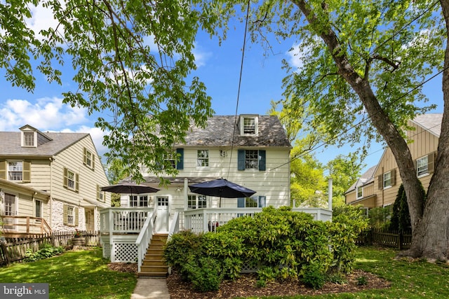 back of property featuring a deck and stairway