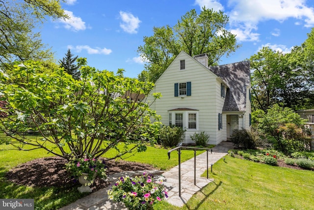 rear view of house with a yard