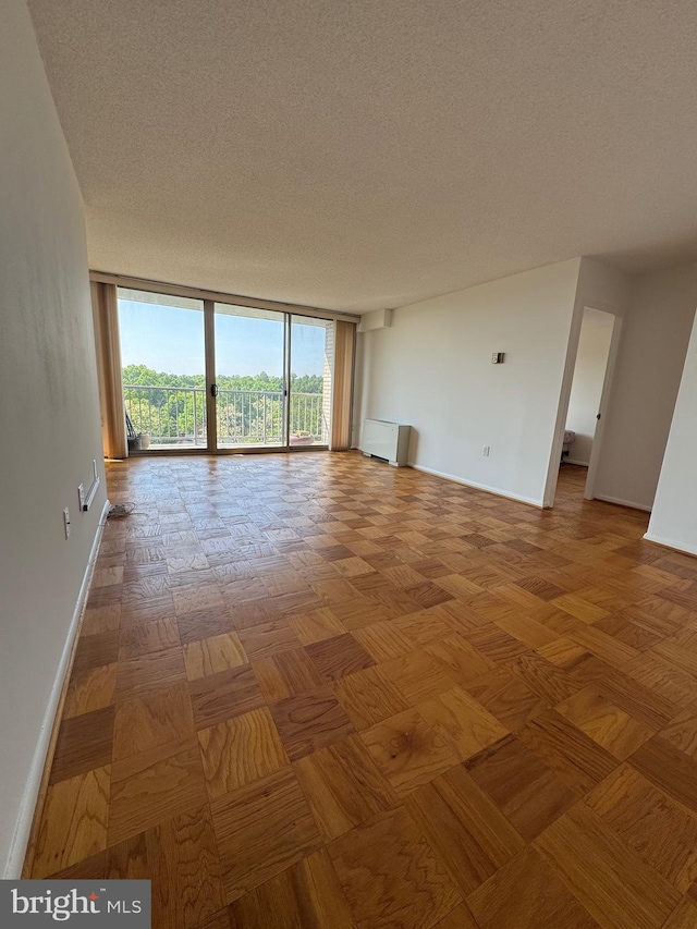 2500 N Van Dorn St Unit 1006, Alexandria, VA 22302 - unfurnished room with expansive windows, baseboards, and a textured ceiling