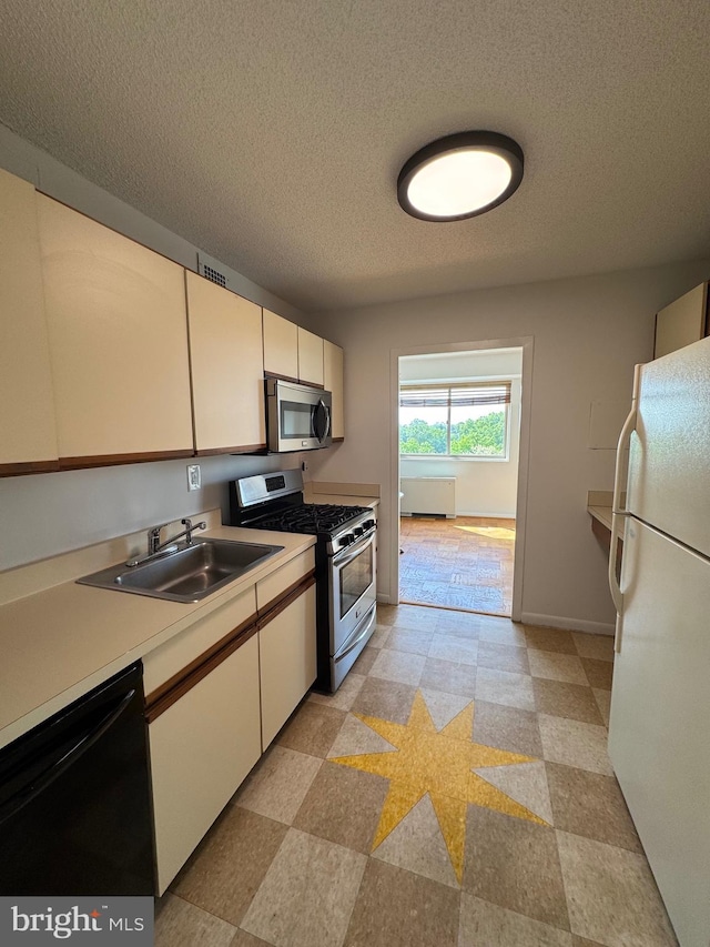2500 N Van Dorn St Unit 1006, Alexandria, VA 22302 - kitchen featuring stainless steel appliances, a sink, light floors, light countertops, and white cabinetry