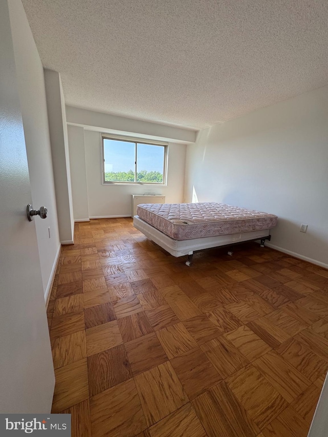 2500 N Van Dorn St Unit 1006, Alexandria, VA 22302 - bedroom featuring a textured ceiling and baseboards