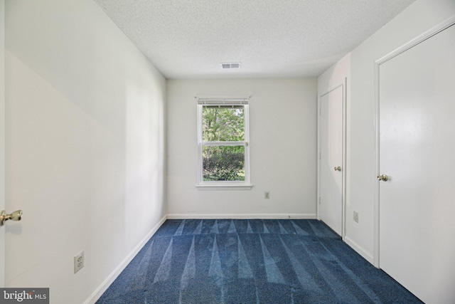 2715 Snowbird Ter Unit 4-28, Silver Spring, MD 20906 - unfurnished bedroom featuring dark colored carpet, a textured ceiling, and baseboards