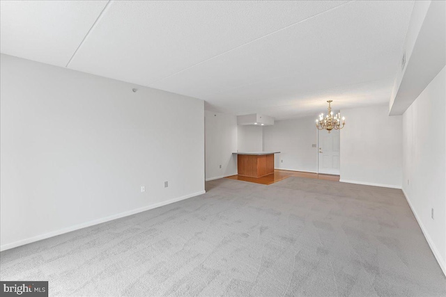 615 Brandon Rd, Norristown, PA 19403 - unfurnished living room featuring a chandelier, light carpet, and baseboards