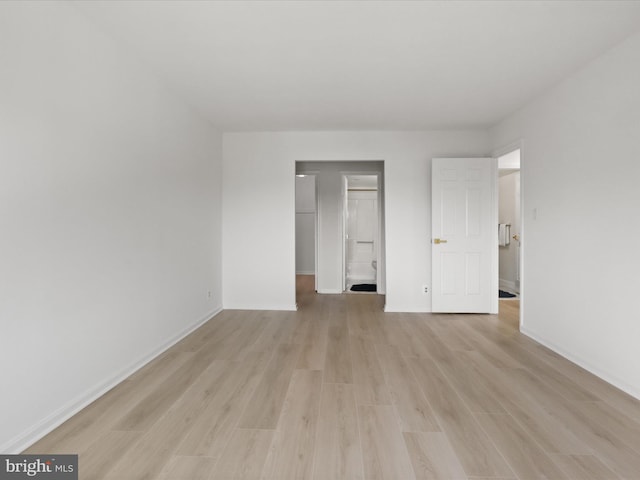 3800 Powell Ln Unit 828, Falls Church, VA 22041 - unfurnished bedroom with a spacious closet, light wood-type flooring, and baseboards