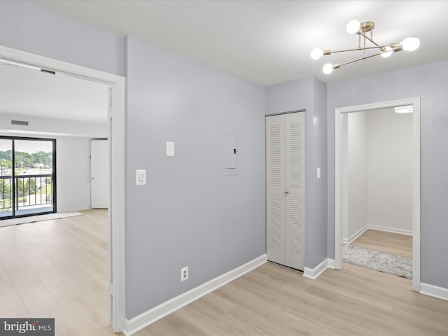 3800 Powell Ln Unit 828, Falls Church, VA 22041 - hallway with wood finished floors, a chandelier, and baseboards