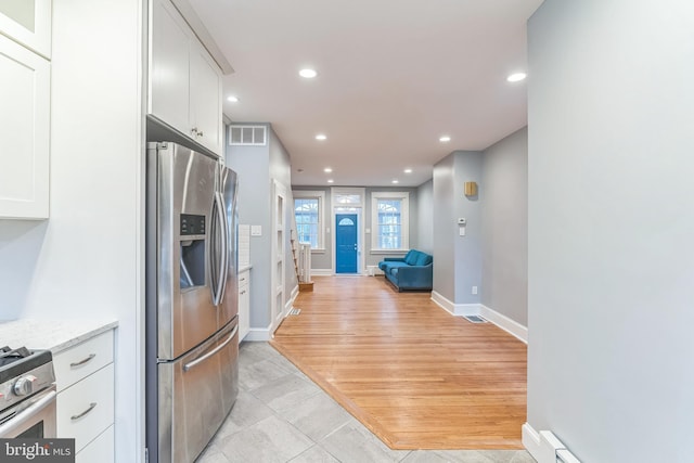 kitchen featuring white cabinets, recessed lighting, visible vents, appliances with stainless steel finishes, and open floor plan