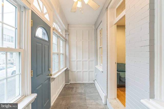 doorway to outside with wood finished floors and ceiling fan