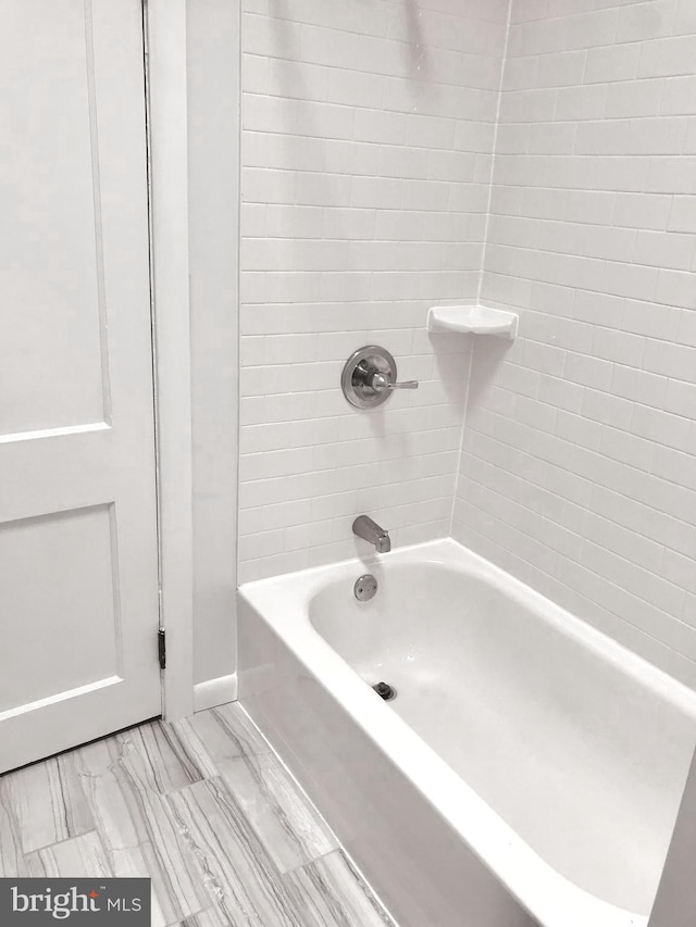 bathroom featuring shower / bathing tub combination and marble finish floor