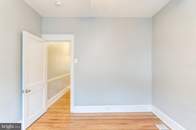 unfurnished room with baseboards, visible vents, and light wood-type flooring