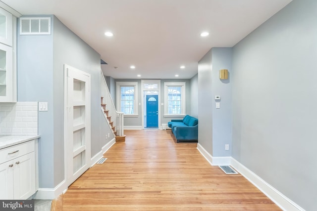 foyer with visible vents, recessed lighting, light wood-style floors, and stairway